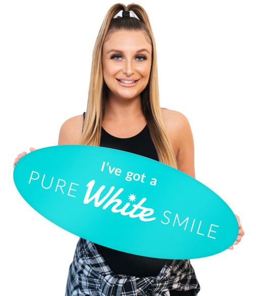 A lady holding "I've got a Pure White Smile" sign